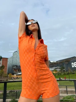 Glamorous Jet Setter|Chic Escapes|Orange Checkerboard Button Through Romper -