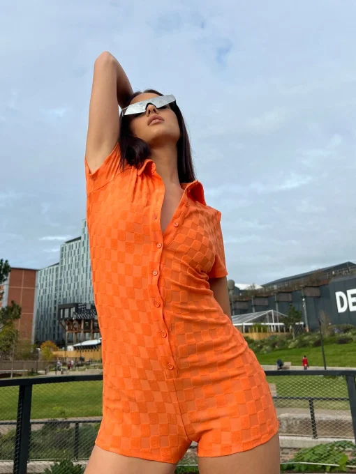 Glamorous Jet Setter|Chic Escapes|Orange Checkerboard Button Through Romper -