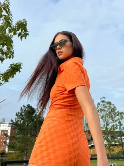 Glamorous Jet Setter|Chic Escapes|Orange Checkerboard Button Through Romper -